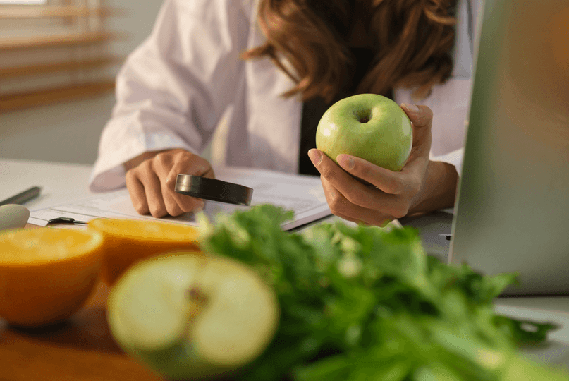 A dietitian holding an apple