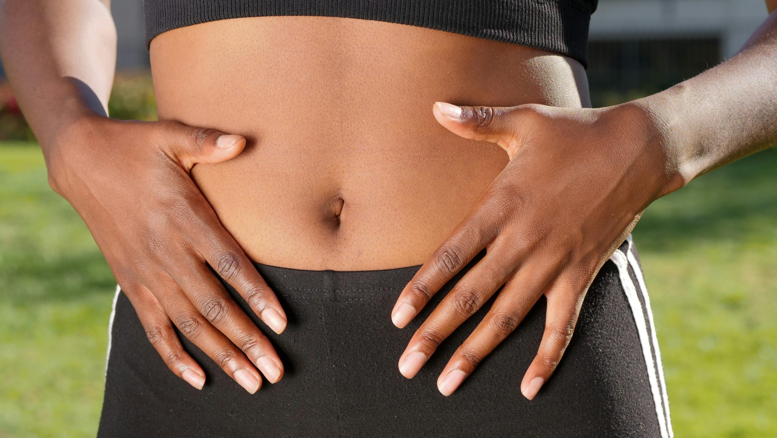 hands over stomach to signify gut health issues